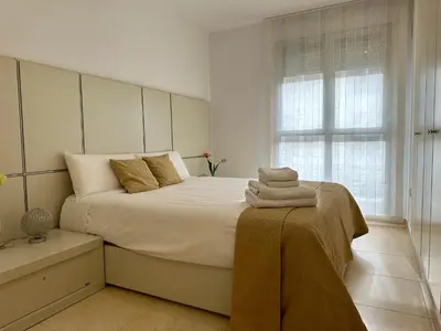 a bedroom with a large bed with towels on it at Reinapart Patacona Beach 40 in Valencia