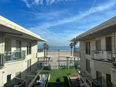 a view of the beach from the balcony of a building at Reinapart Patacona Beach 40 in Valencia