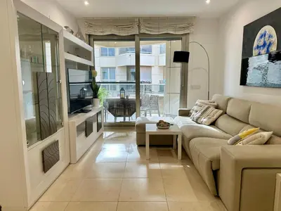 a living room with a couch and a table at Reinapart Patacona Beach 40 in Valencia