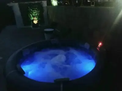 a blue hot tub in a yard at night at Buen Estar, piscina, barbacoa, jacuzzi en Valencia in Turís
