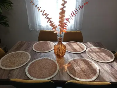 a wooden table with plates and a vase on it at Buen Estar, piscina, barbacoa, jacuzzi en Valencia in Turís