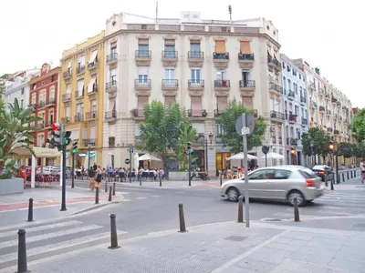 a car driving on a city street with buildings at ApartUP Valencia Opera in Valencia