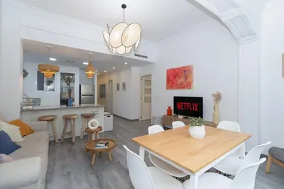 a living room and kitchen with a table and chairs at GuestReady - El Cabanyal Hidden Oasis in Valencia