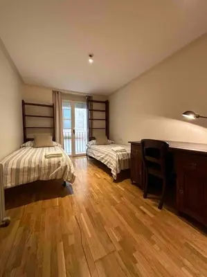 a bedroom with two beds and a wooden floor at Apartamento Almas Centro in Valencia
