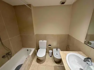 a bathroom with a tub and a toilet and a sink at Apartamento Almas Centro in Valencia