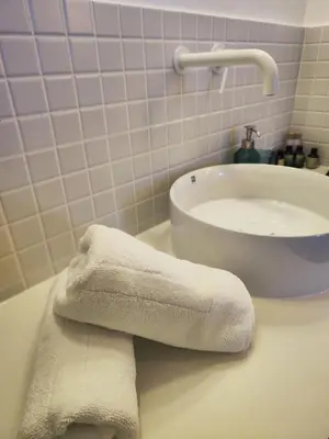 a bathroom with two towels on a counter next to a sink at CariSan1 - 6 min to beach, modern, bright in Valencia