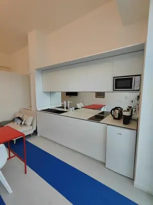a kitchen with a white counter top and a microwave at CariSan1 - 6 min to beach, modern, bright in Valencia