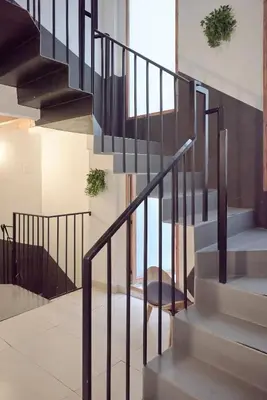 a staircase with black railings in a house at Sunny Cozy Penthouse with a Terrace at Plaza del Carmen in Valencia