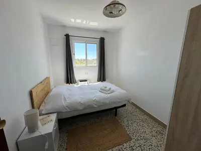 a small bedroom with a bed and a window at La Casa de Matilde in Caudiel