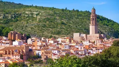 a town on a hill with a clock tower at La Casa de Matilde in Caudiel