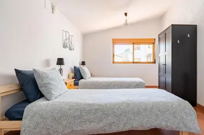a bedroom with two beds and a window at Casa la Baronia in Chulilla