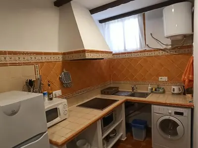 a small kitchen with a sink and a microwave at Casa la Baronia in Chulilla