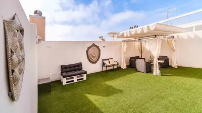 a room with a green lawn in the middle of a house at Ático Balinés con vistas al mar in Canet de Berenguer