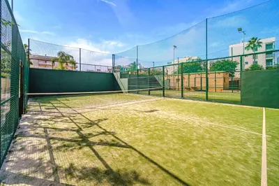 a tennis court with a net on top of it at Ático Balinés con vistas al mar in Canet de Berenguer