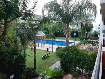 a view of a swimming pool with trees and a bench at Casa Lliri con piscina en Massalfassar VALENCIA in Masalfasar