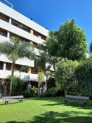 two benches in a park in front of a building at Casa Lliri con piscina en Massalfassar VALENCIA in Masalfasar