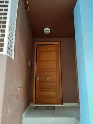 a hallway with a wooden door in a building at Casa Lliri con piscina en Massalfassar VALENCIA in Masalfasar