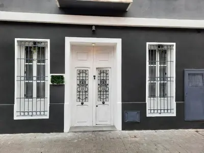 a white door and two windows on a black building at Bonito Alojamiento F in Valencia