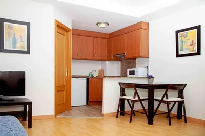 a kitchen with a table and chairs in a room at A studio-apartment in a newly built house.WIFI in Valencia