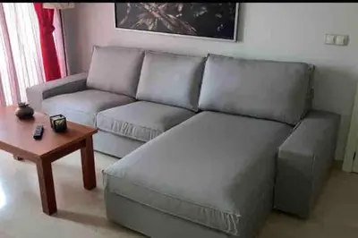 a living room with a couch and a coffee table at Piso acogedor con vistas al mar in La Torre