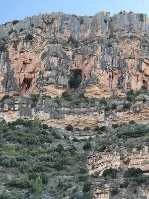 a large rocky mountain with some dwellings in it at Apartamento Rural Piedra in Jérica