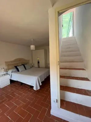 a bedroom with a bed and a staircase in it at Apto. Rural Cielo. Al lado Torre in Jérica