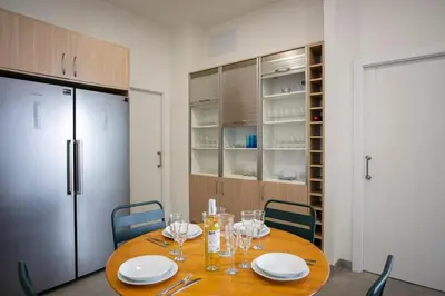 a dining room table with plates and wine glasses at SingularStays Picaña in Picanya