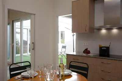 a kitchen with a table with wine glasses on it at SingularStays Picaña in Picanya