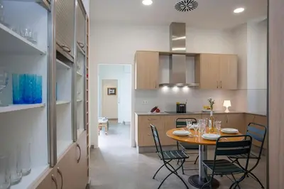 a kitchen and dining room with a table and chairs at SingularStays Picaña in Picanya