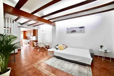 a living room with a bed and a dining room at Apartamento con Terraza cerca de la Estación del Nord in Valencia