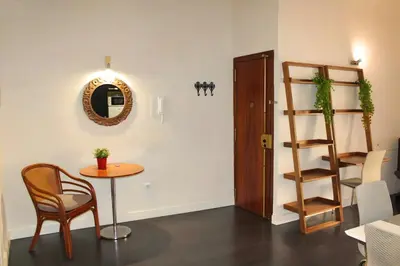 a room with a table and a chair and a shelf at Apartamento reformado cerca de la Plaza Redonda in Valencia