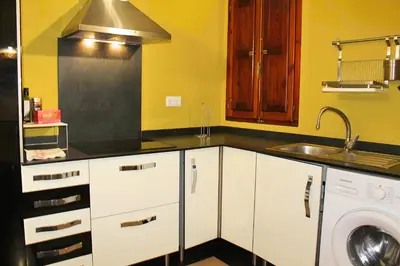 a kitchen with a sink and a washing machine at Apartamento reformado cerca de la Plaza Redonda in Valencia