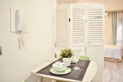 a table with two plates and glasses on it at Estudio con encanto en el casco antiguo de Valencia in Valencia