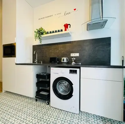a laundry room with a washer and dryer at Dorado Cabanyal - Luxury Beachside Charm in Valencia