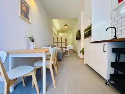 a kitchen and dining room with a table and chairs at Lindo Cabanyal - Comfort Family Beachside Apartment in Valencia