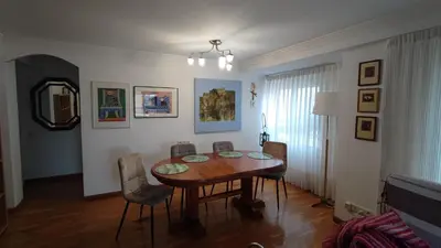 a dining room with a wooden table and chairs at Precioso apartamento a 7 minutos en tren al centro de Valencia in Benetúser