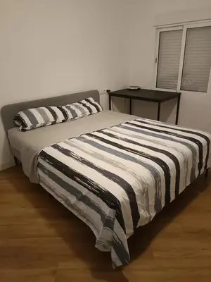 a bed with two pillows on it in a bedroom at vip rooms patraix in Valencia