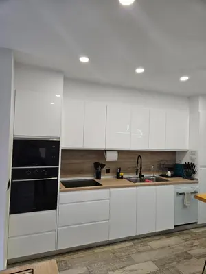 a kitchen with white cabinets and a black appliance at Habitación céntrica de Lujo Gv 6 in Valencia