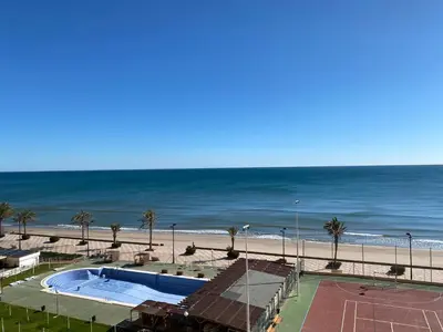 a view of a beach with a swimming pool and the ocean at Travel Habitat Port Saplaya con vistas al Mar in Port Saplaya