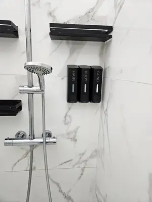 a bathroom with white marble walls and a stool at Habitación céntrica de Lujo Gv 3 in Valencia