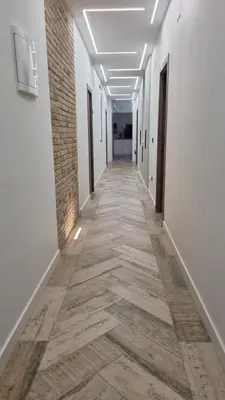 a corridor of an office building with white walls and wooden floors at Habitación céntrica de Lujo Gv 5 in Valencia