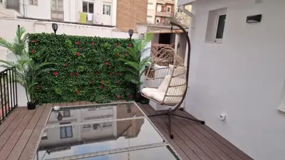 a chair sitting on a balcony with a garden at Habitación céntrica de Lujo Gv 5 in Valencia