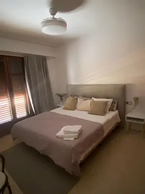 a bedroom with a large bed with towels on it at La casa de bega de mar in Sueca