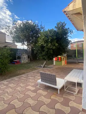 a patio with two benches and a solar panel on it at La casa de bega de mar in Sueca