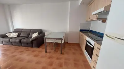 a living room with a couch and a table at Ático dúplex con vistas in Canet de Berenguer