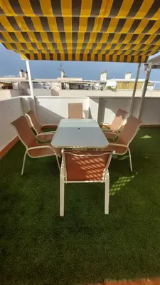 a table and chairs on top of a boat at Ático dúplex con vistas in Canet de Berenguer