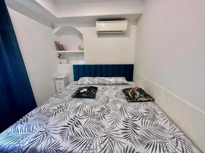 a bedroom with a bed with two pillows on it at Piso Lorena Playa 1min walk in Puerto de Sagunto