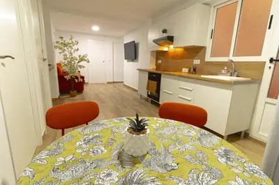 a kitchen and a table with a pineapple on it at ¡A disfrutar de Valencia! in Valencia