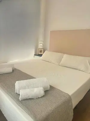 a bedroom with two white towels on a bed at Valencia Bella Flats in Valencia
