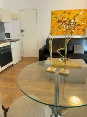 a living room with a glass table in front of a couch at Valencia Bella Flats in Valencia